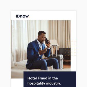 man sitting on a sofa in a suit talking on the phone next to his suitcase